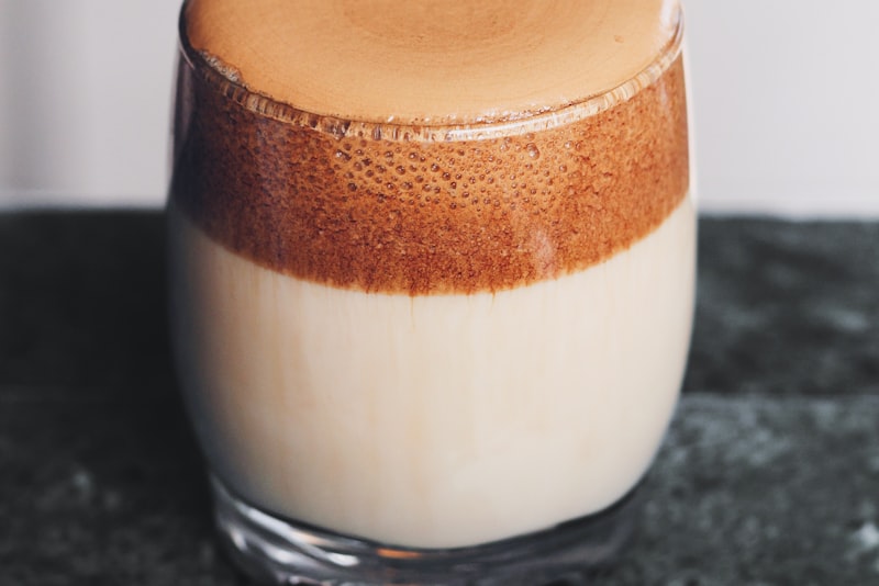 An AeroPress coffee maker sitting on a mug on a wooden kitchen surface.